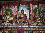 Tibet Kailash 10 Kora 03 Zutulpuk Gompa Altar The monk allowed me to take one photo inside Zutulpuk Gompa - here is the main altar featuring Avalokiteshvara (Chenrezig), Shakyamuni, and Padmasambhava (Guru Rinpoche).